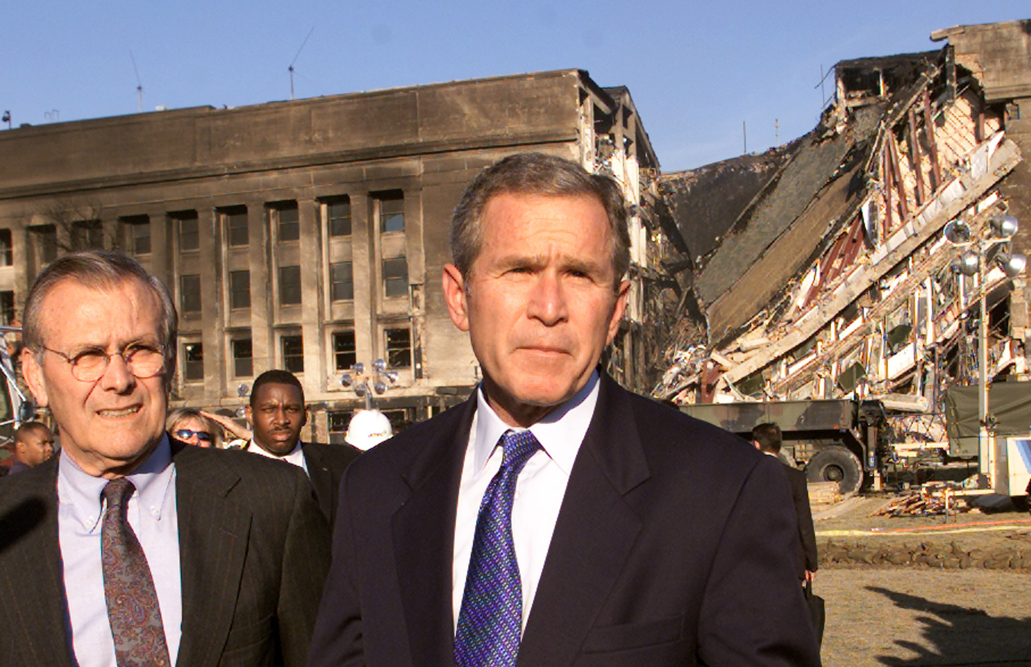 Secretary of Defense Donald Rumsfeld and President George W. Bush speak in front of the west side of the Pentagon September 12, 2001 -- the same spot where terrorists plunged an airliner earlier the day before. (Photo: REUTERS/Kevin Lamarque/Newscom)