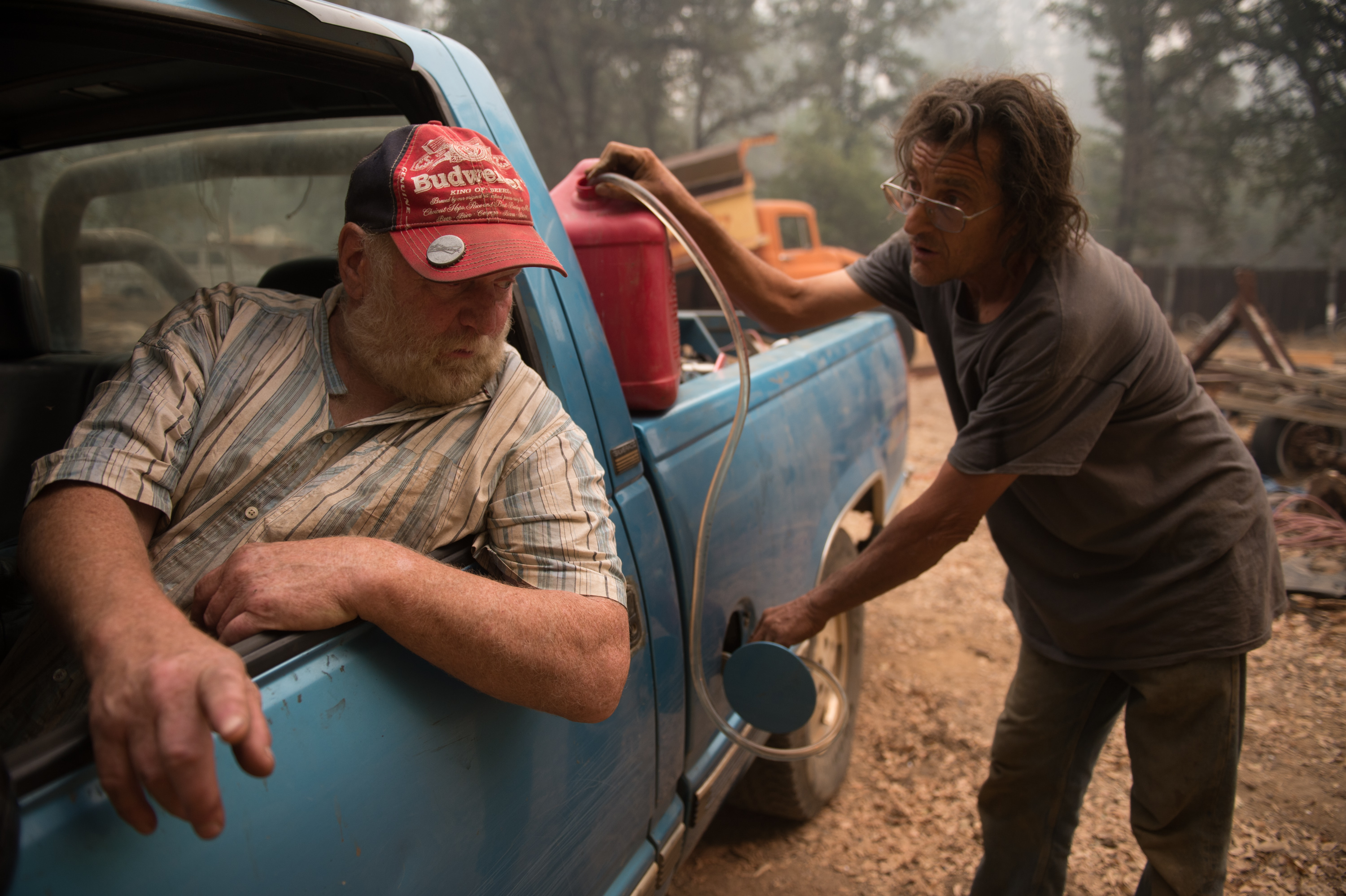 Norman Gussell  fills Steven Van Jones’ tank up with gas in Jackson, Calif. Gov. Jerry Brown declared a state of emergency Friday afternoon in Calaveras  and Amador Counties as many attempt to evacuate. (Photo: Andrew Seng/Newscom)