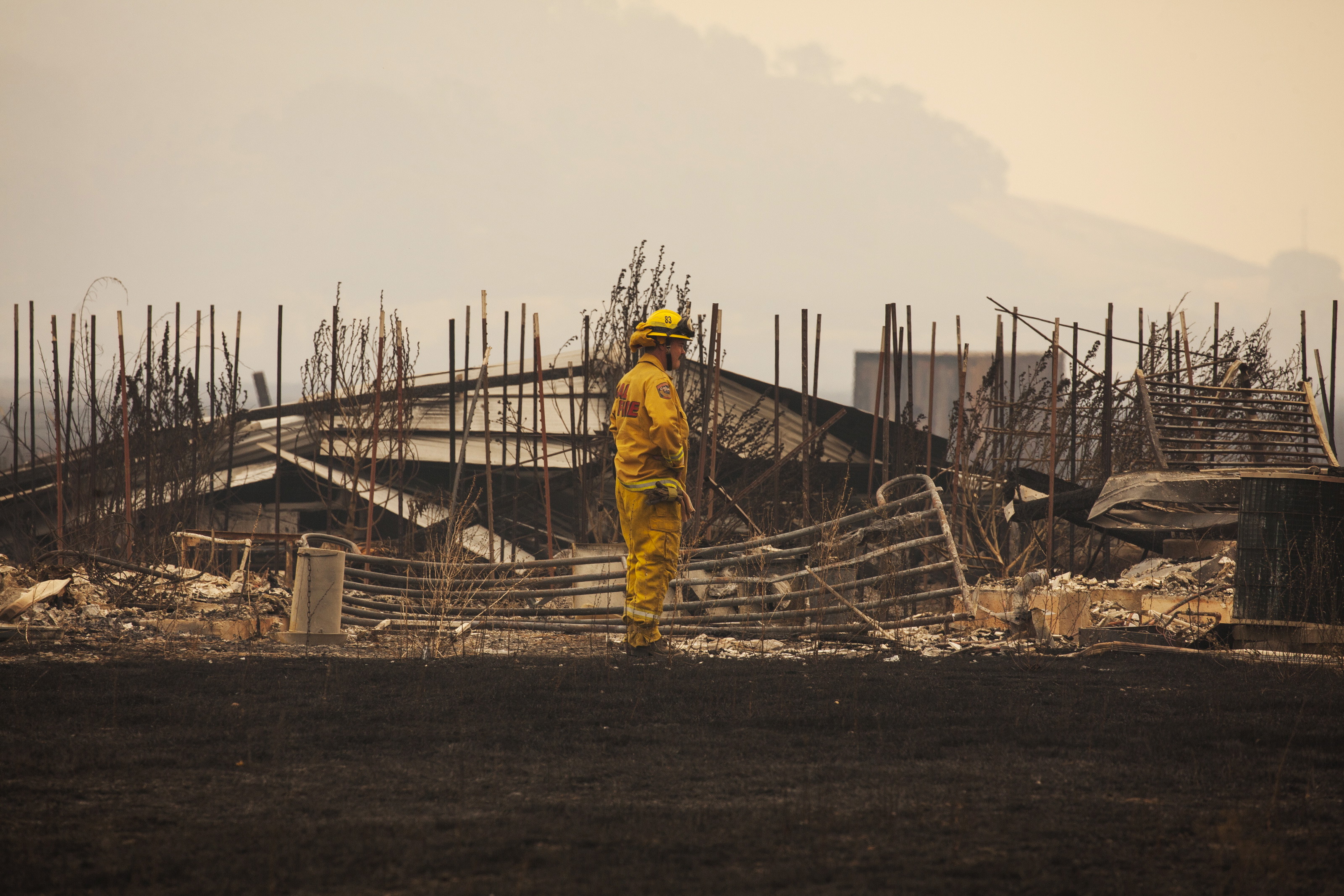 A firefighter surveys a destroyed home at the “Valley Fire” near Middleton, California, September 14, 2015. Fire officials saying they expect the property toll to climb. (Photo: REUTERS/David Ryder/Newscom)