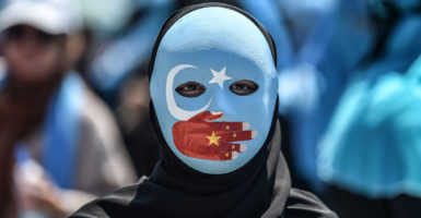 At least 1 million Uighurs—a Chinese ethnic-Muslim minority—have been sent to “political re-education camps” to erase their identity and assimilate them into the Han majority for the purposes of conforming their religious beliefs to the party’s beliefs. Pictured: A demonstrator attends a protest to denounce China's treatment of ethnic Uighur Muslims during a deadly riot in July 2009 in Urumqi, in front of the Chinese consulate in Istanbul, on July 5, 2018. - (Photo: Ozan Kose/AFP/Getty Images)