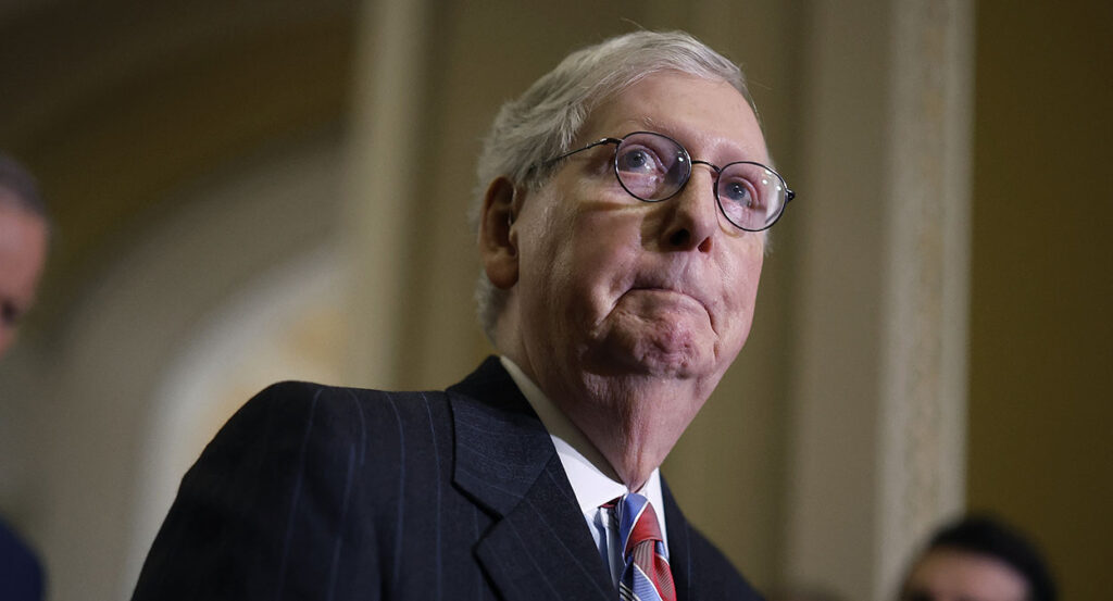 Mitch McConnell gulps in a suit