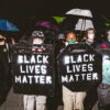 Men in masks with Black Lives Matter shields