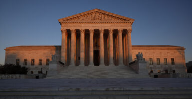 The Supreme Court building with the sun setting