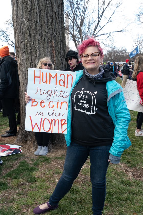 Woman hold sign reading human rights begin in the womb