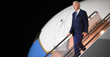 Joe Biden in a suit in front of Air Force One