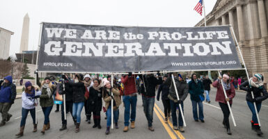 March for Life protesters carry "We are the pro-life generation" sign