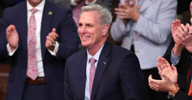 Kevin McCarthy smiling as others clap around him