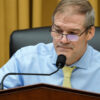 Jim Jordan in a blue shirt with a yellow tie