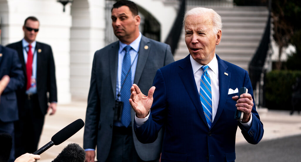 Joe Biden gestures in a blue suit