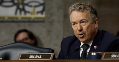 Rand Paul in a suit behind a name tag