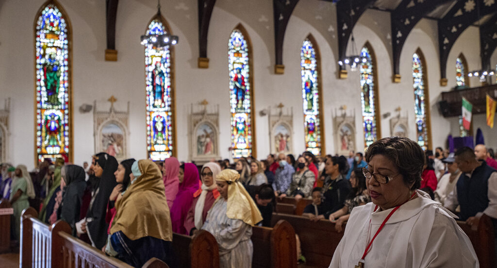 Christians observe Good Friday in a Catholic church.