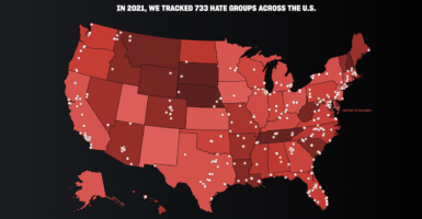 A map of the United States in red with SPLC-accused "hate groups" in white