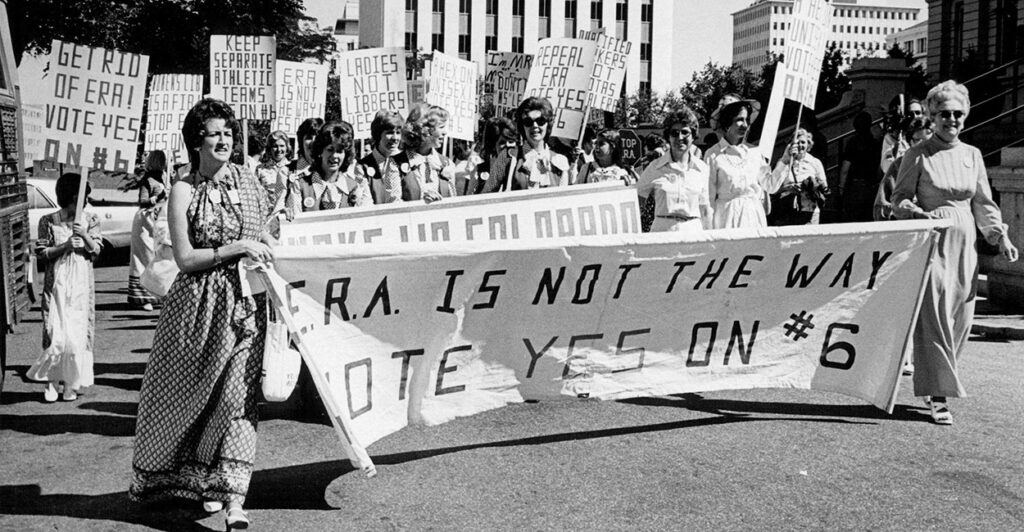 Women march in 1976 holding a sign reading "ERA Is Not the Way."