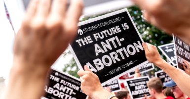 Anti-abortion activists hold signs outside the U.S. Supreme Court