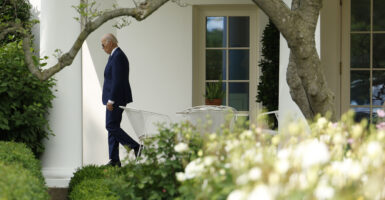 President Joe Biden walks in front of the White House.