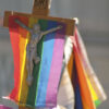 A crucifix with a rainbow flag
