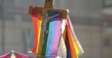 A crucifix with a rainbow flag