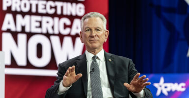 Sen. Tommy Tuberville sitting on stage at CPAC