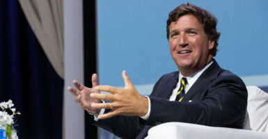 Tucker Carlson on stage at Heritage Foundation Gala