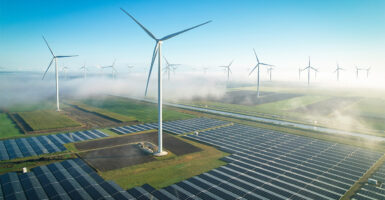 Solar panels and wind turbines in fog