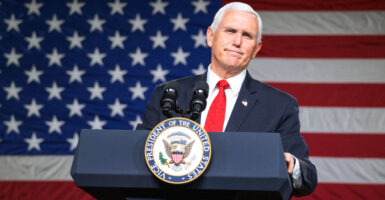 Mike Pence stands at a podium in front of an American flag