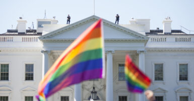 A prominent Washington, D.C. restaurant group beloved by lawmakers on both sides of the aisle is celebrating Pride Month with a weekend drag brunch steps from the White House. Pictured: Demonstrators carry rainbow flags past the White House during the Equality March for Unity and Peace on June 11, 2017 in Washington, D.C. Thousands around the country participated in marches for the LGBTQ communities, the central march taking place in Washington. (Photo by Zach Gibson/Getty Images)