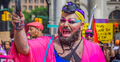 Male with bear dresses as a pink drag queen