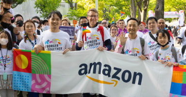 People hold Amazon Pride banner in Pride Parade.