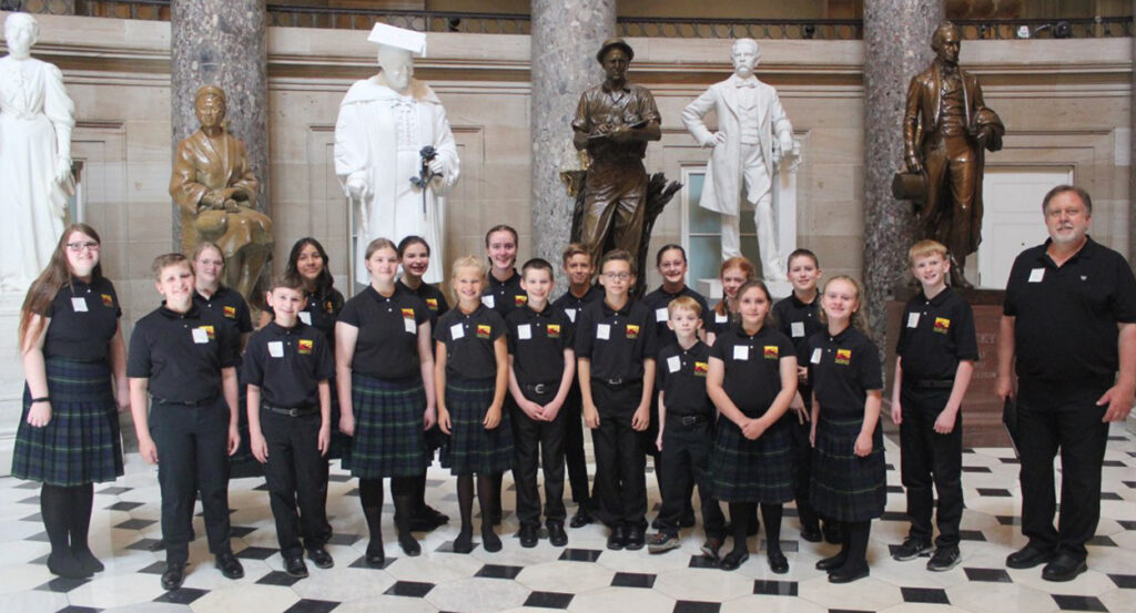 The Rushingbrook Children's Choir in suits and dresses in Statuary Hall
