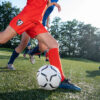A girl prepares to kick a soccer ball during a soccer game.