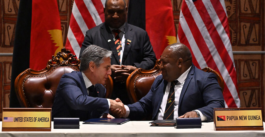 Secretary of State Antony Blinken and Papua New Guinea's Defense Minister Win Bakri Daki shake hands