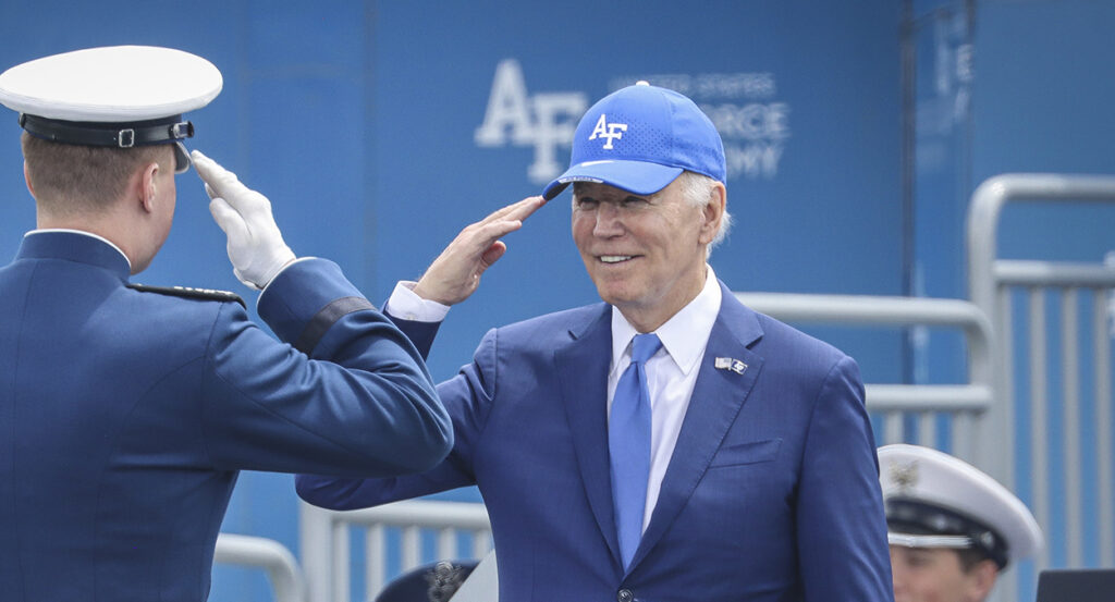 President Joe Biden salutes in a blue suit