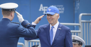 President Joe Biden salutes in a blue suit