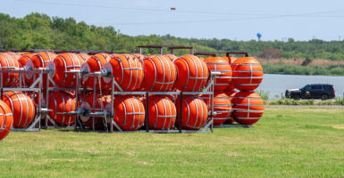 Large orange buoys sit on the bank of the Rio Grande.