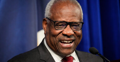 Justice Clarence Thomas smiles while speaking at an event at The Heritage Foundation.