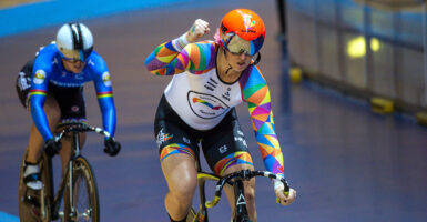 Two cyclists competing on an indoor track