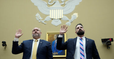IRS agents Gary Shapley and Joseph Ziegler raise hands to take oath before testifying on Capitol Hill