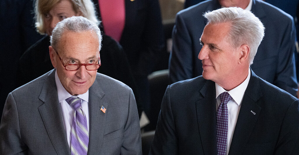 Senate Majority Leader Chuck Schumer, D-N.Y., left, and Speaker of the House Kevin McCarthy, R-Calif., sit side by side as they attend an event in the Capitol