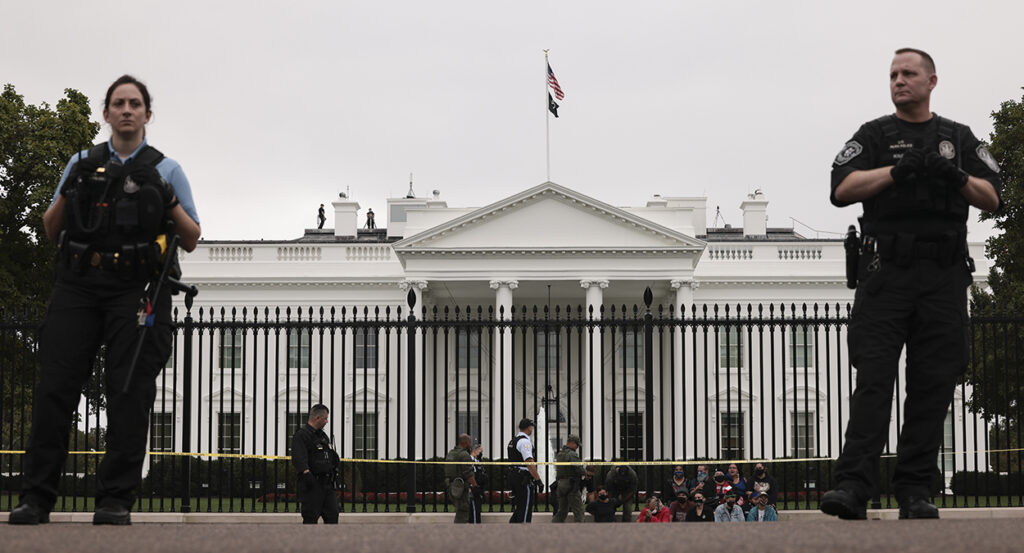 Secret Service stand in front of the White House