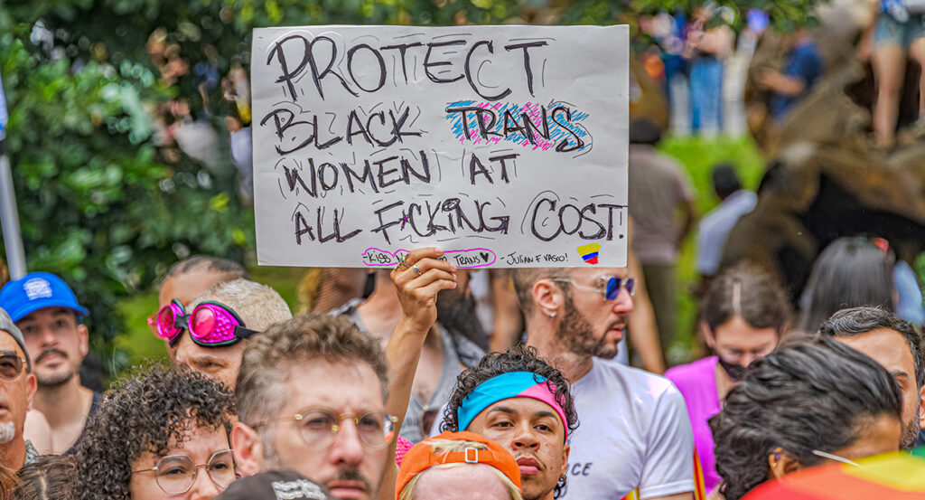 Protester holds sign reading "protect black trans women."