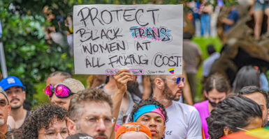 Protester holds sign reading "protect black trans women."