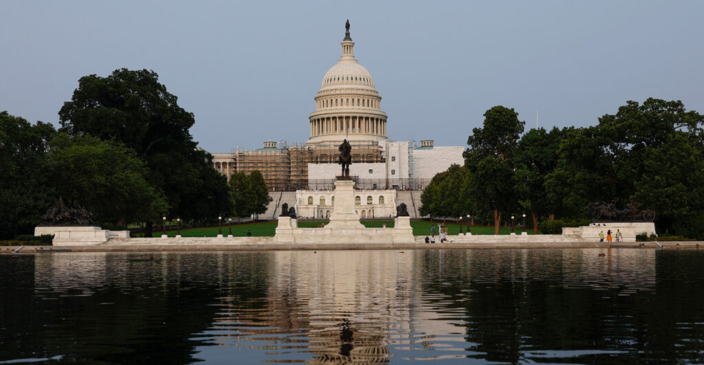 The U.S. Capitol building is seen across a pool of water on Capitol Hill.