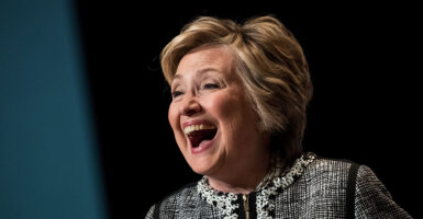 Hillary Clinton laughs in a dress