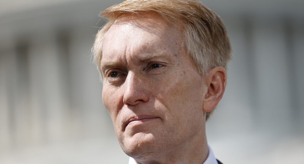 James Lankford stares with the U.S. Capitol building in the background