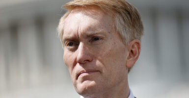 James Lankford stares with the U.S. Capitol building in the background