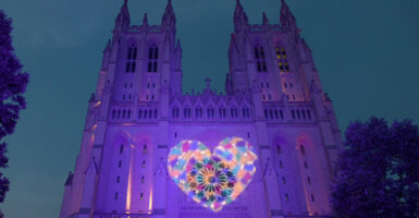 The National Cathedral in blue with a rainbow heart