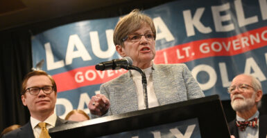 Kansas Governor Laura Kelley speaks in front of a sign with her name on it