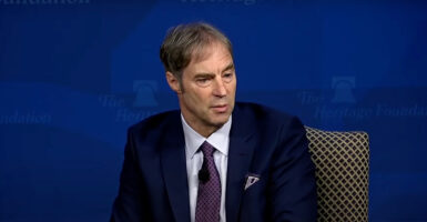 Stephen Meyer speaks from stage at The Heritage Foundation while seated.