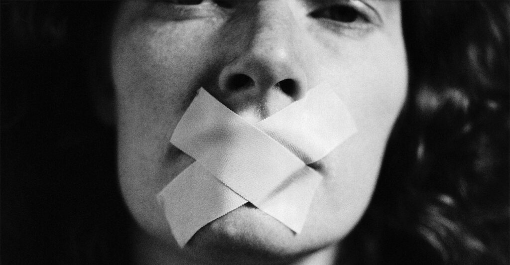 Woman with tape over her mouth