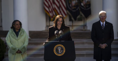 Kamala Harris stands at a podium outdoors to give a speech
